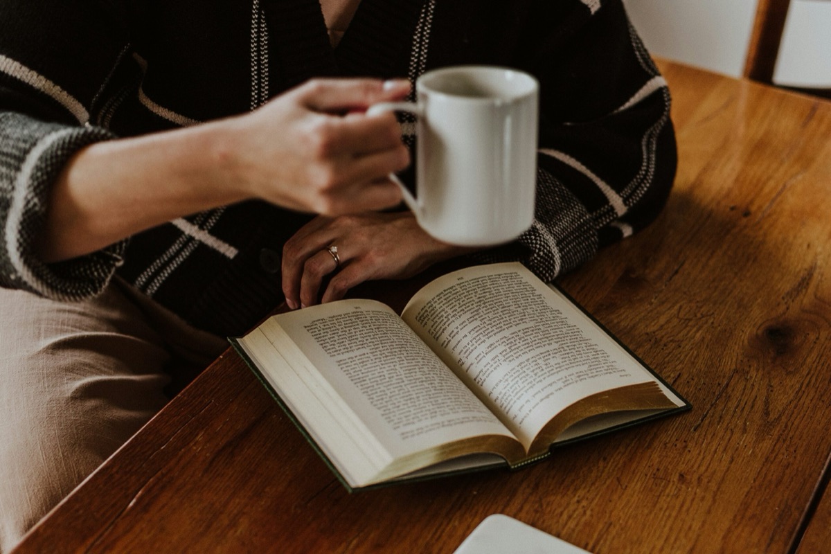 Reading a book with a cup of coffee
